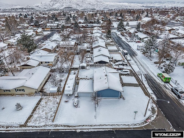 snowy aerial view with a residential view