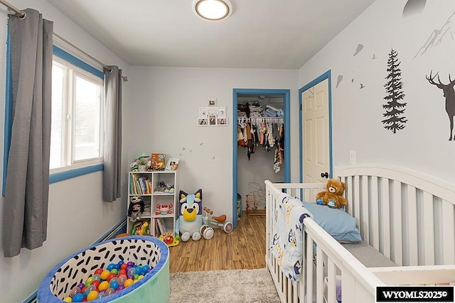 bedroom with a closet and wood finished floors