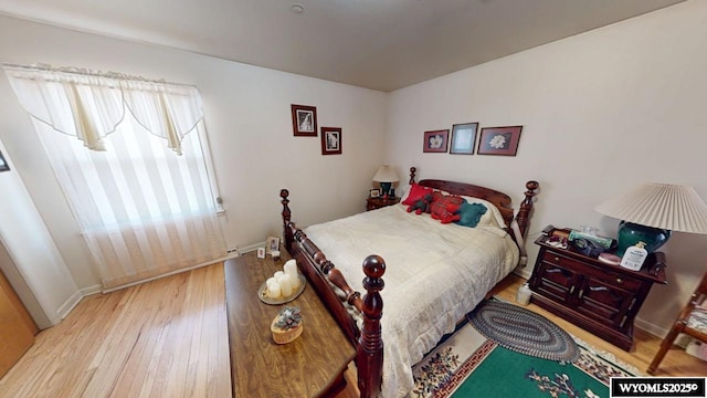 bedroom with wood finished floors and baseboards