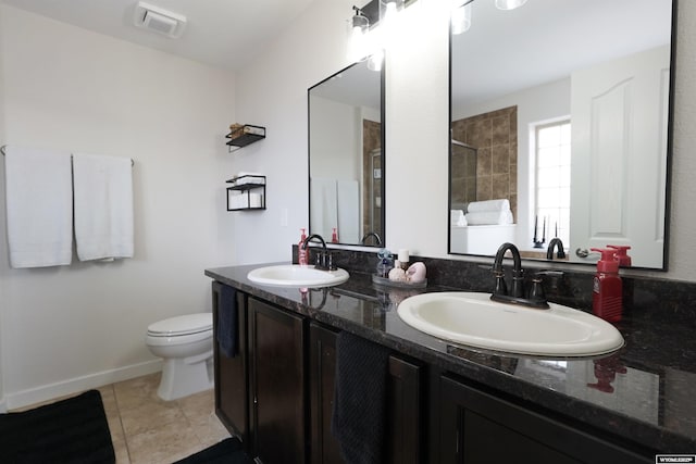 full bathroom with tile patterned flooring, a shower with door, a sink, and visible vents