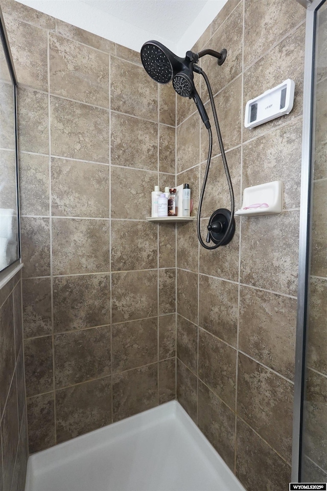 full bathroom with a tile shower