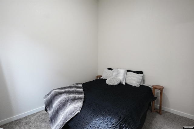 bedroom featuring baseboards and carpet flooring