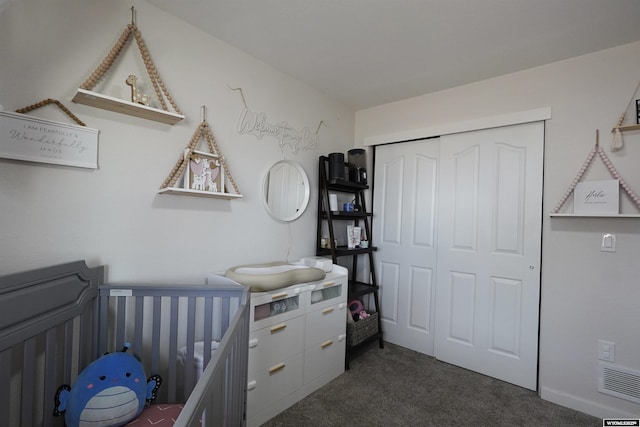 bedroom featuring a closet, dark carpet, and visible vents