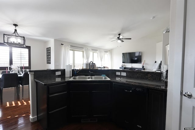 kitchen with ceiling fan with notable chandelier, dark wood-style flooring, a sink, open floor plan, and dishwasher