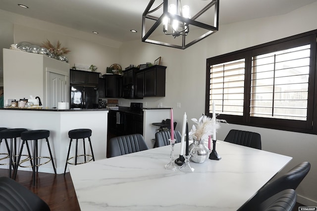 dining space featuring dark wood finished floors and recessed lighting