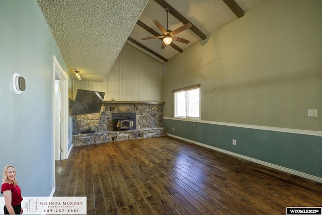 unfurnished living room with high vaulted ceiling, wood-type flooring, a textured ceiling, and beam ceiling