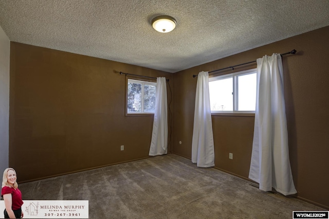 unfurnished bedroom with a textured ceiling and carpet