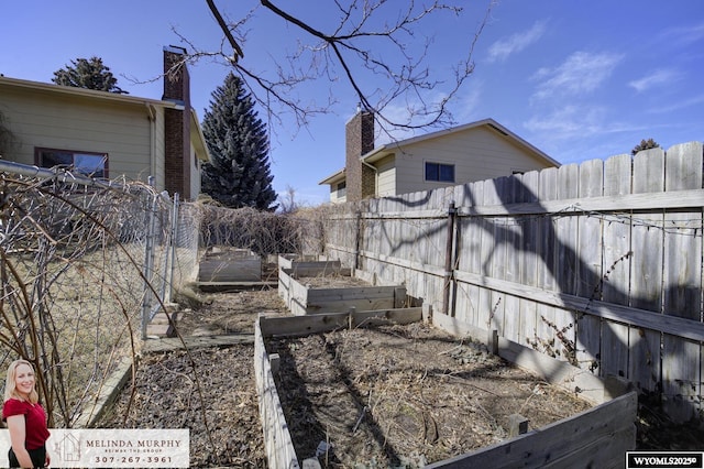 view of yard with fence and a garden