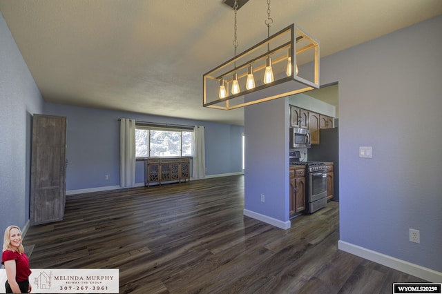 unfurnished dining area with dark wood-type flooring and baseboards