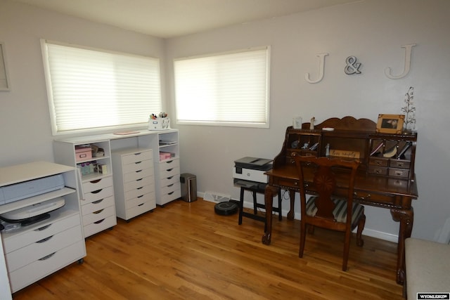 office space featuring light wood-style flooring and baseboards