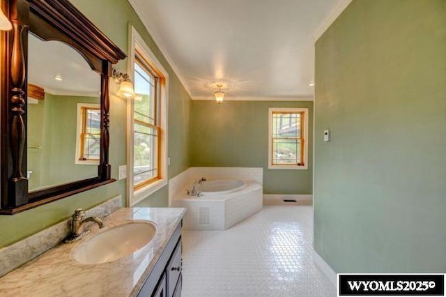 full bathroom with a garden tub, ornamental molding, a wealth of natural light, and vanity