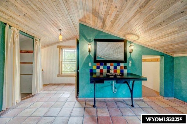 interior space featuring lofted ceiling, wooden ceiling, and tile patterned floors