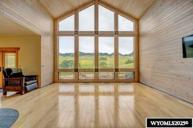 living room with wood ceiling, light wood-style flooring, and high vaulted ceiling