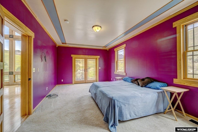 bedroom featuring carpet, french doors, crown molding, and baseboards