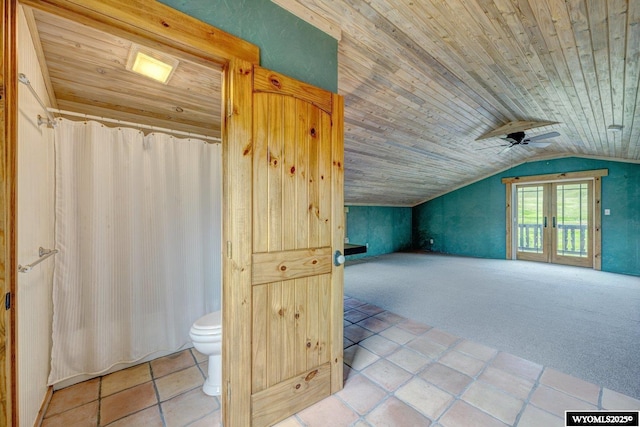 additional living space with wood ceiling, carpet flooring, ceiling fan, vaulted ceiling, and tile patterned floors