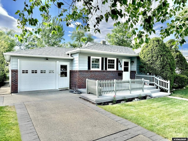 ranch-style home featuring an attached garage, concrete driveway, brick siding, and a front yard