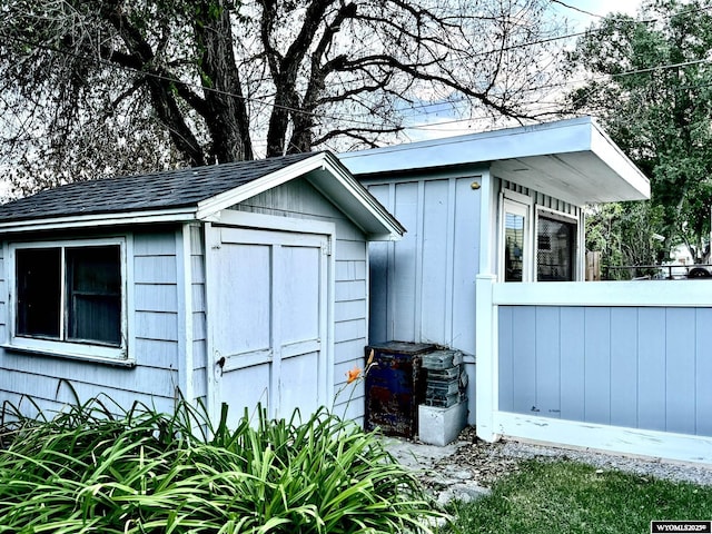 view of shed featuring fence