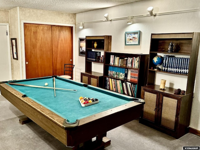 playroom with a textured ceiling, carpet floors, and pool table