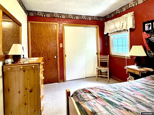 carpeted bedroom with a textured ceiling