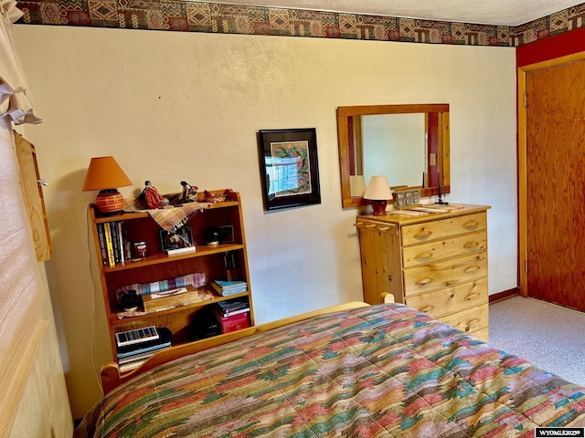 bedroom with baseboards and carpet flooring