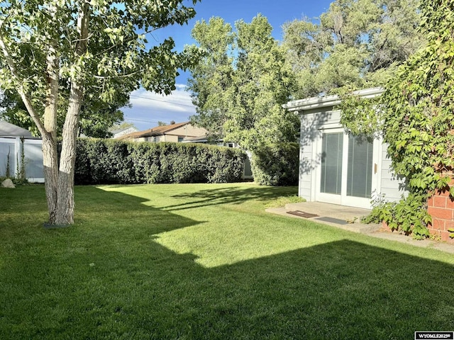 view of yard with an outdoor structure and fence