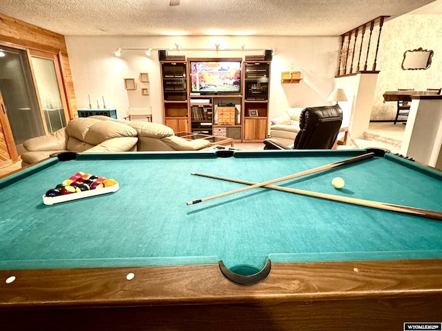 recreation room with a textured ceiling and pool table