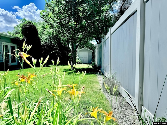 view of yard featuring a storage unit and an outbuilding