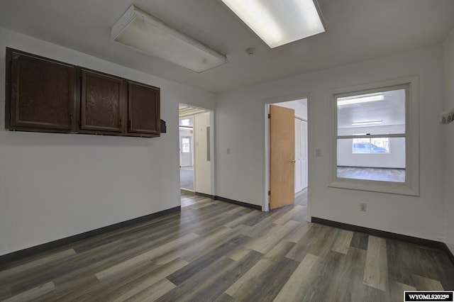 spare room with wood finished floors and baseboards