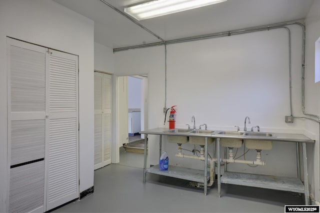 interior space with concrete floors and a sink