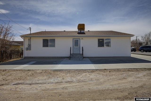 back of house featuring entry steps, a patio area, and fence