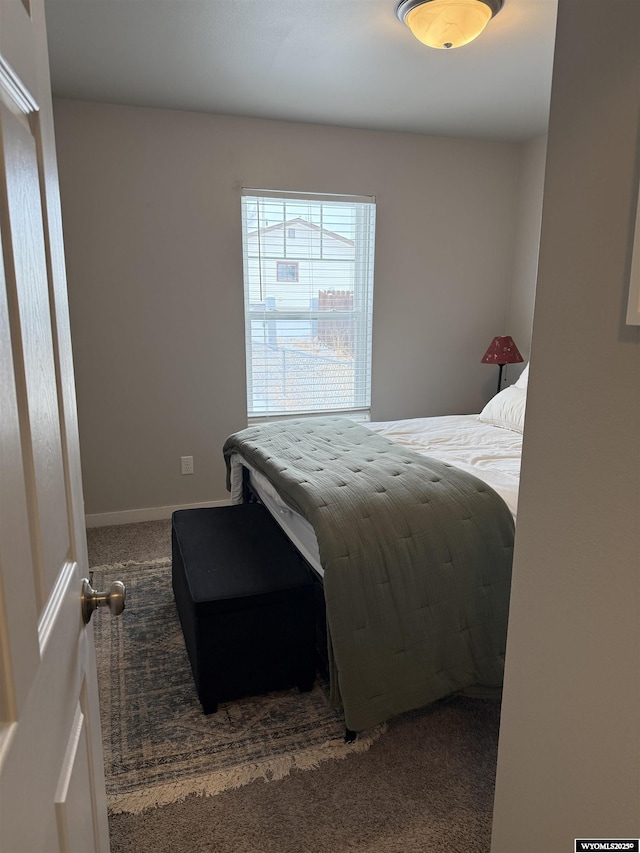 bedroom featuring baseboards and carpet flooring