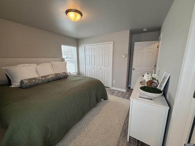 bedroom featuring a closet, baseboards, and wood finished floors