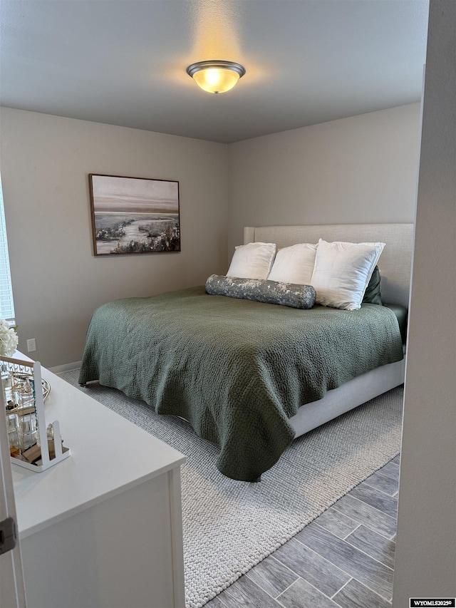 bedroom featuring wood finish floors