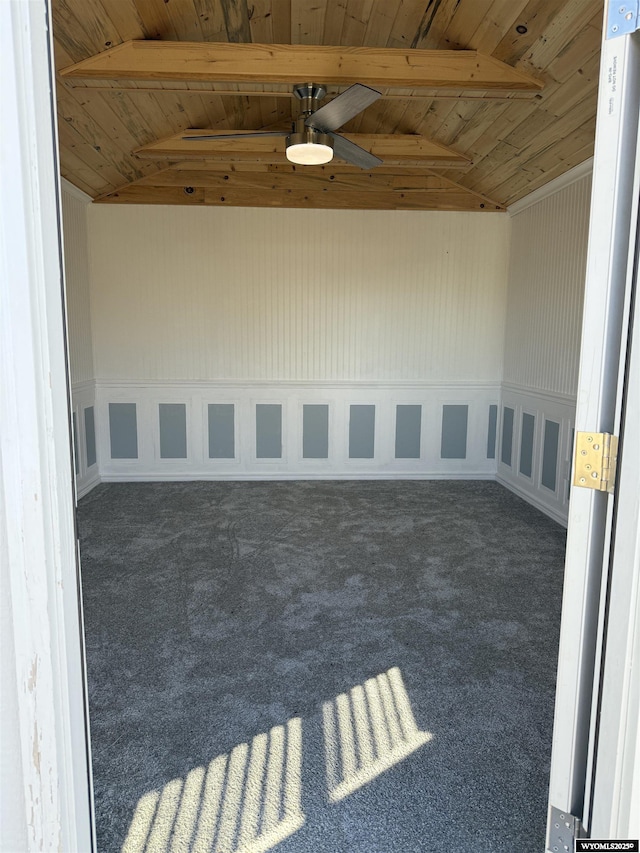 empty room featuring carpet, wooden ceiling, and lofted ceiling with beams