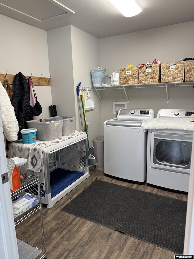 clothes washing area with laundry area, independent washer and dryer, and wood finished floors