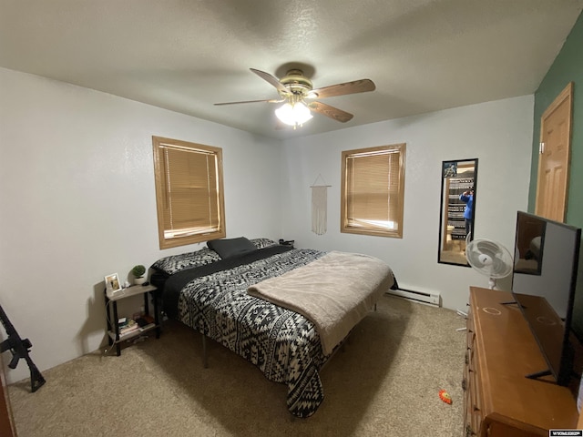 carpeted bedroom featuring ceiling fan and baseboard heating