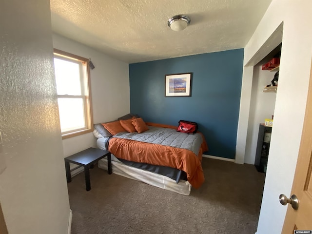 bedroom featuring a textured ceiling and carpet