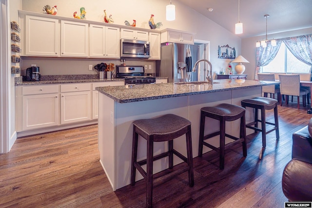 kitchen featuring stainless steel appliances, dark wood-type flooring, and white cabinetry