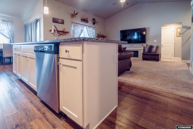 kitchen featuring lofted ceiling, white cabinets, open floor plan, stainless steel dishwasher, and plenty of natural light