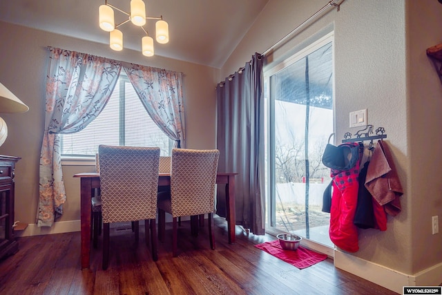 dining space featuring plenty of natural light, hardwood / wood-style flooring, and an inviting chandelier