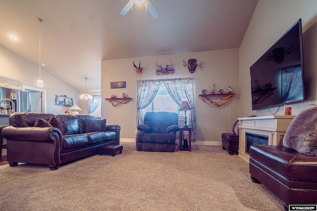 living room with lofted ceiling, light colored carpet, ceiling fan with notable chandelier, baseboards, and a glass covered fireplace