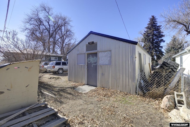 view of outbuilding featuring an outbuilding and fence