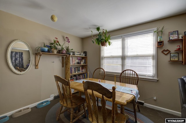 dining space featuring baseboards