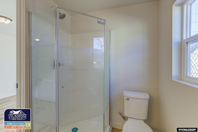 bathroom with a shower stall and toilet