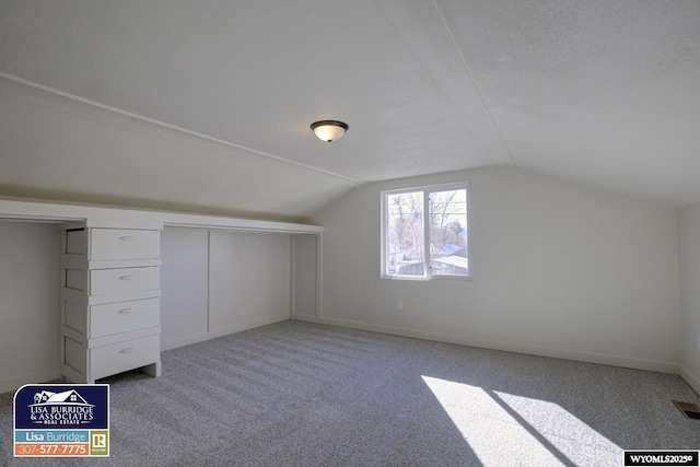 bonus room featuring lofted ceiling, baseboards, and carpet floors