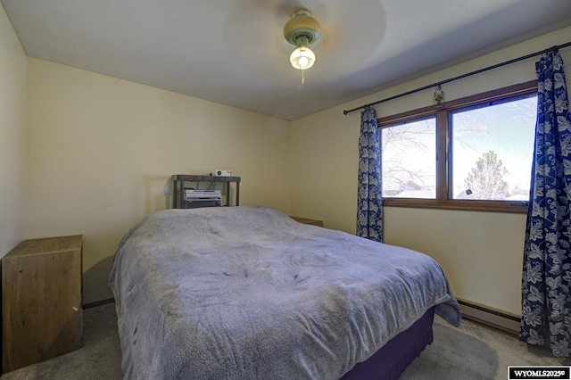 bedroom featuring carpet, a baseboard heating unit, and a ceiling fan