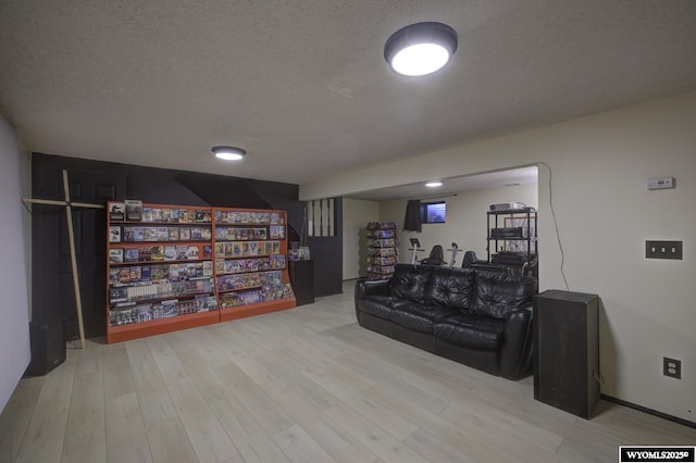 living area with a textured ceiling and wood finished floors