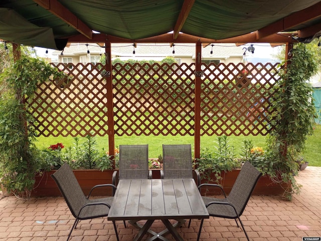 view of patio / terrace with outdoor dining space and fence