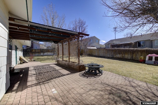 view of patio with an outdoor fire pit and fence