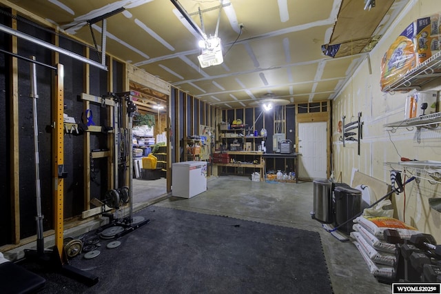 basement with a garage and a workshop area